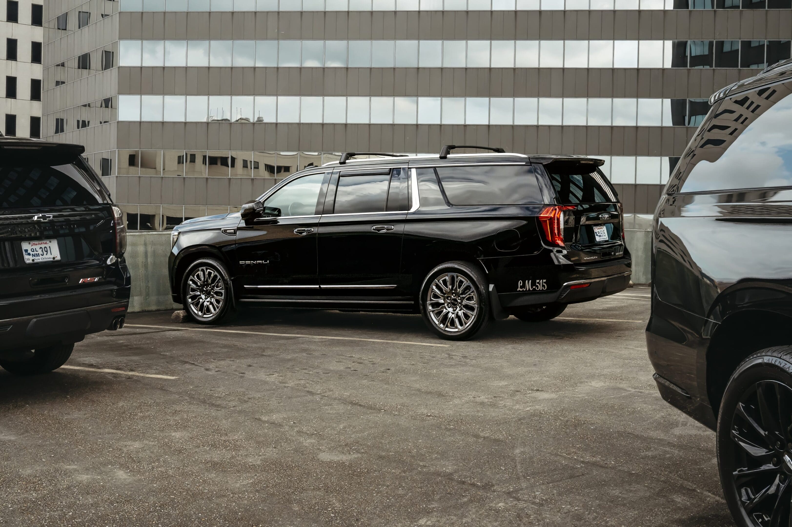 A black car parked in the parking lot